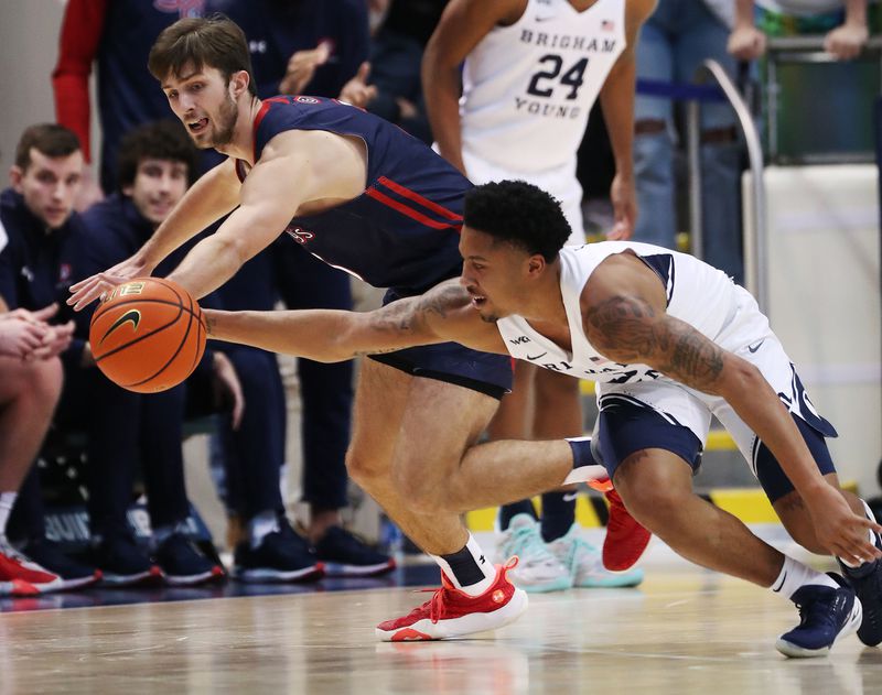 Brigham Young Cougars guard Te’Jon Lucas (3) and Saint Mary’s Gaels guard Augustas Marciulionis (3) compete for the ball in Provo on Saturday, Jan. 8, 2022.
