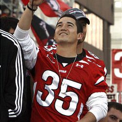 Utah's All-American kicker Louie Sakoda takes a photo as the University of Utah football players, coaches, band, cheerleaders and dignitaries are honored with a parade and pep rally in downtown Salt Lake City Friday. 