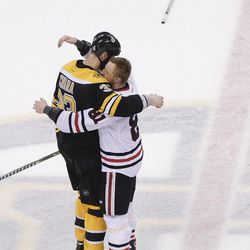 Boston Bruins defenseman Zdeno Chara (33), hugs Chicago Blackhawks right wing Marian Hossa (81), both of Slovakia, after the Blackhawks beat the Bruins 3-2 in Game 6 of the NHL hockey Stanley Cup Finals, Monday, June 24, 2013, in Boston. 
