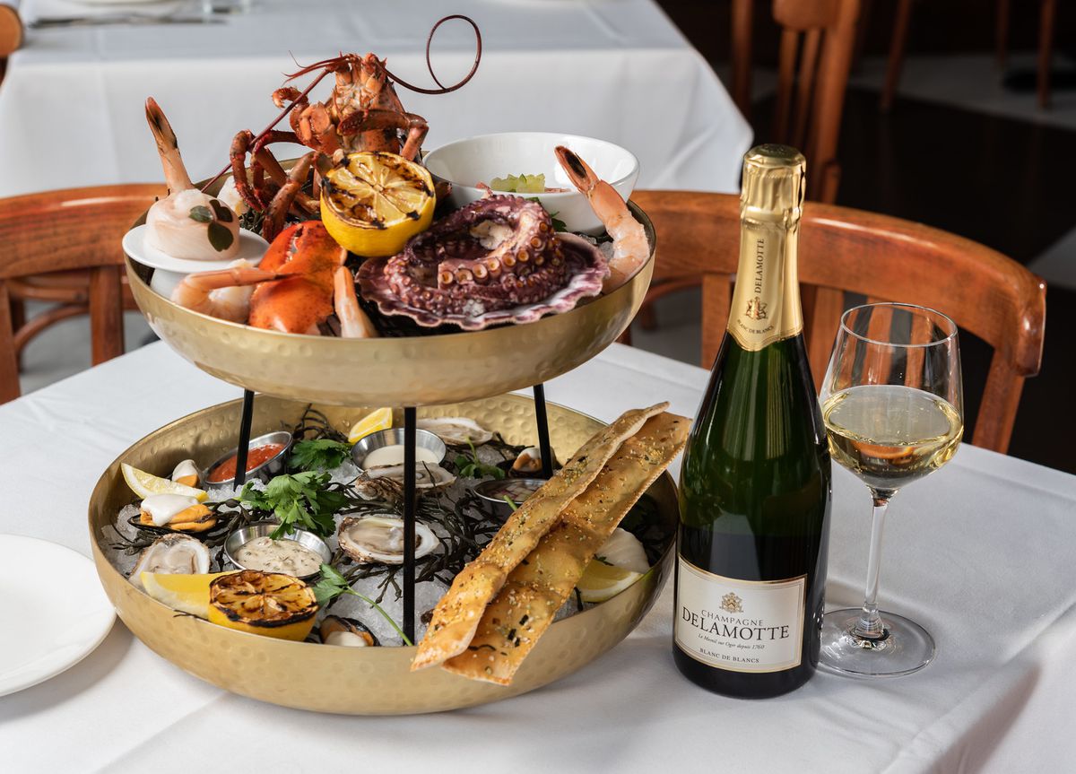 A seafood tower and a bottle of Champagne