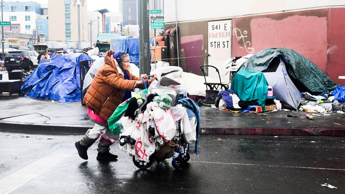 A woman walks past a row of tents in Los Angeles on February 1.
