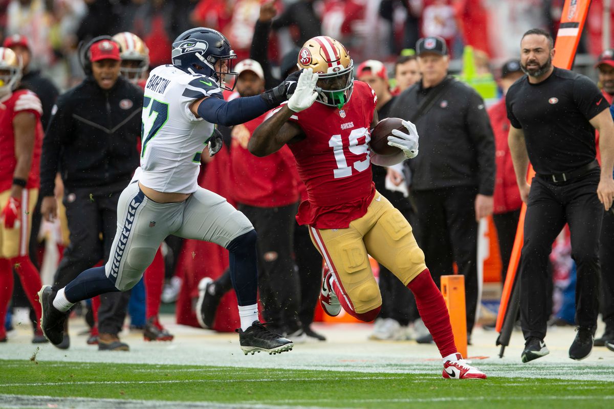 Deebo Samuel #19 of the San Francisco 49ers runs after making a catch against the Seattle Seahawks during the NFC Wild Card playoff game at Levi’s Stadium on January 14, 2023 in Santa Clara, California. The 49ers defeated the Seahawks 41-23.