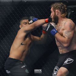 Deron Winn and Tom Lawlor exchange punches.