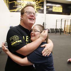 James Fitzgerald hugs his girlfriend, Lisa Wilson, at Gold's Gym in Ogden on Monday, Dec. 5, 2016. Fitzgerald, who has Down syndrome, teaches a fitness class with his brother, Evan, specifically for people with disabilities.