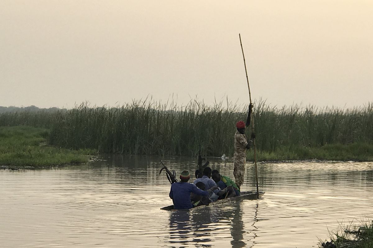 Ganyiel village — rebels travelling between various posts on traditional canoe.