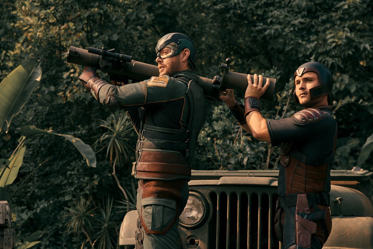 Soldier Boy holding a rocket launcher with another supe backing him up; Soldier Boy is looking sideways towards the camera