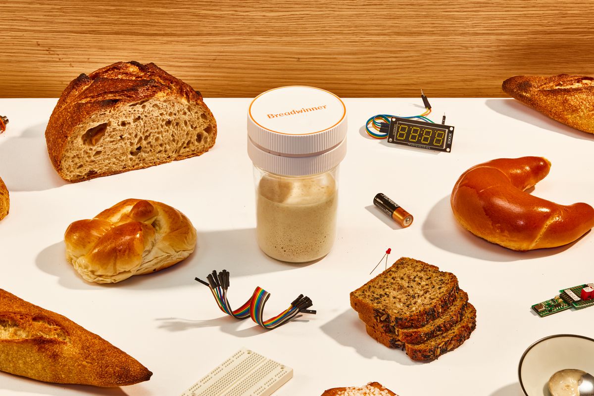 The Breadwinner starter tracking device sits in the middle of the photo, surrounded by various breads and technology components.