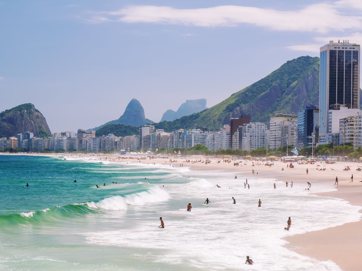 The Copacabana Beach in Rio de Janeiro. The beach is adjacent to city buildings.