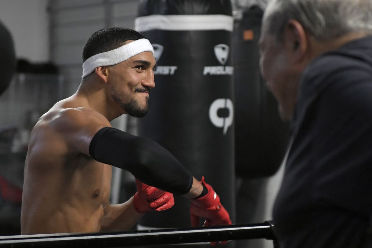 Teofimo Lopez (L) speaks with Top Rank Founder and CEO Bob Arum during a media workout at the City Athletic Boxing Gym on November 04, 2021 in Las Vegas, Nevada.