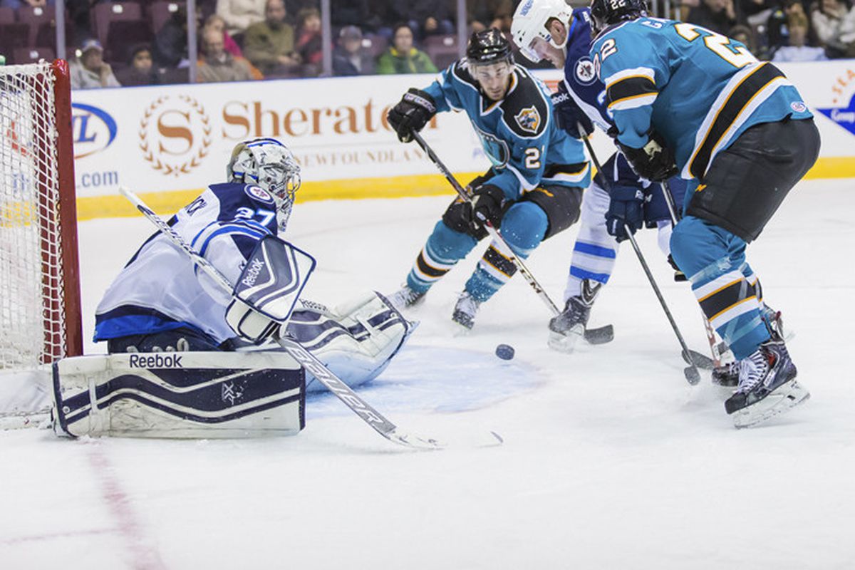 Worcester Sharks forwards Travis Oleksuk and Ryan Carpenter crash the net for a rebound during Friday night's game against the St. John's IceCaps at the Mile One Centre (www.stjohnsicecaps.com)