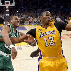 FILE - Boston Celtics center Jason Collins battles Los Angeles Lakers center Dwight Howard (12) for a rebound during the first half of their NBA basketball game, Wednesday, Feb. 20, 2013 in Los Angeles. NBA veteran center Collins has become the first male professional athlete in the major four American sports leagues to come out as gay. Collins wrote a first-person account posted Monday, April 29, 2013 on Sports Illustrated's website.
