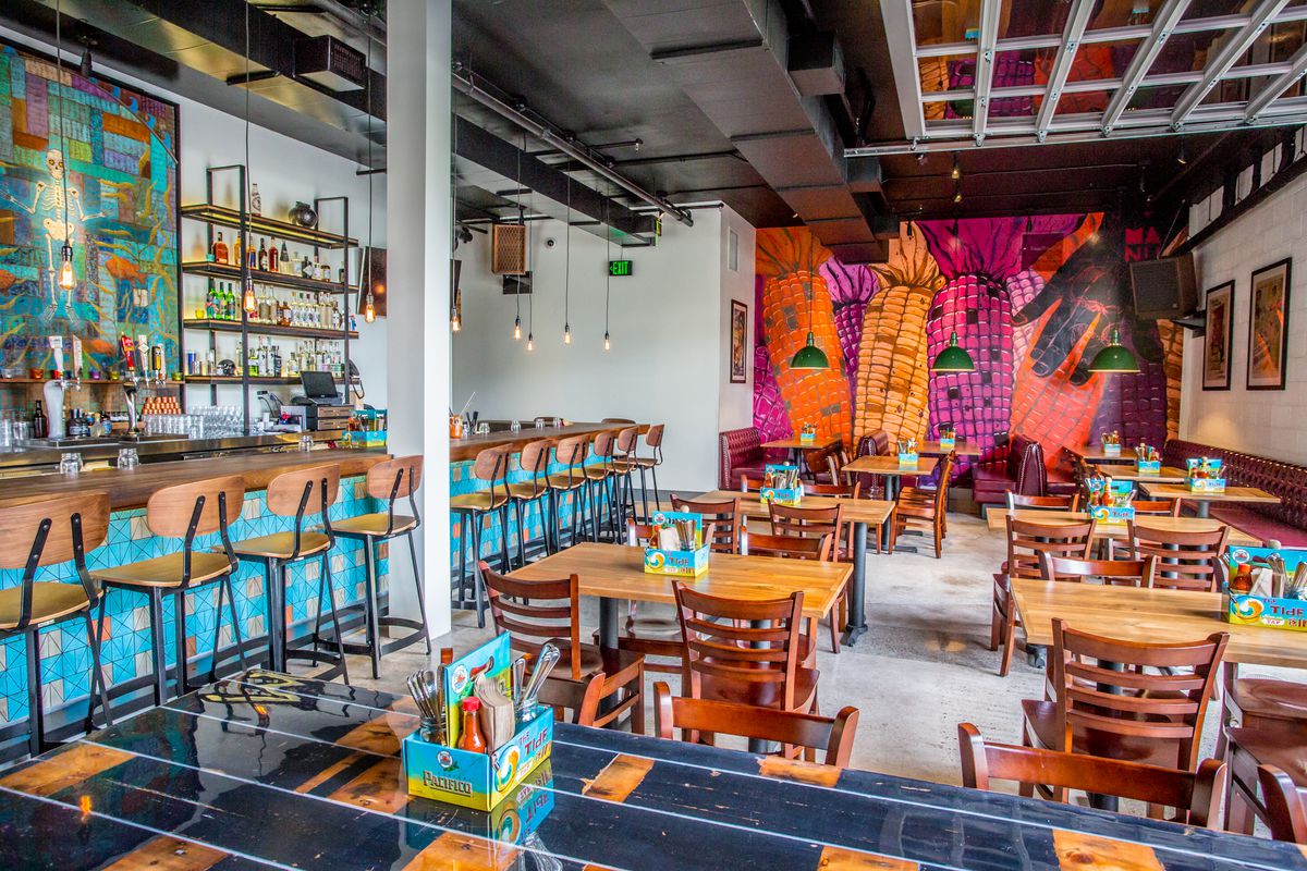 Bar and dining room with colorful corn mural at Galaxy Taco.