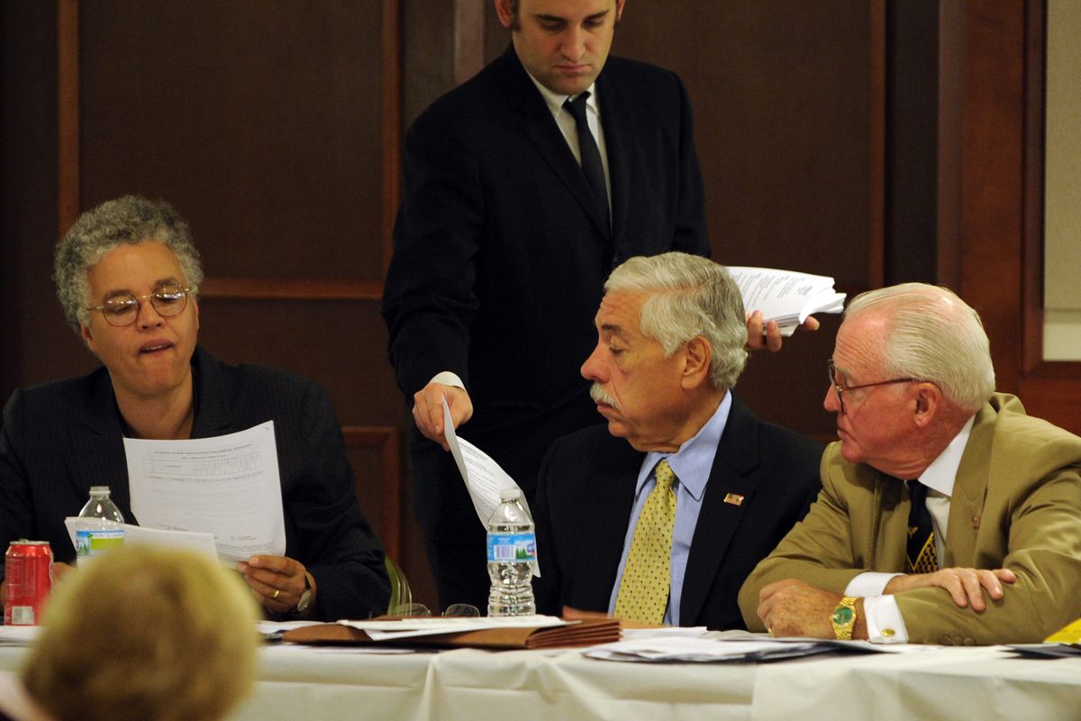 Scott Cisek, then executive director of the Cook County Democratic Party, passes out resumes of judicial candidates to Cook County Board President Toni Preckwinkle; then-Party Chairman and Cook County Assessor Joe Berrios and Ald. Edward M. Burke (14th) a