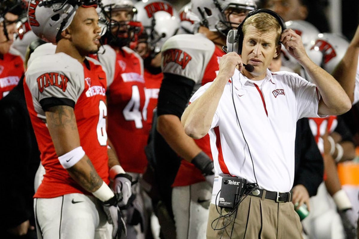 LAS VEGAS - NOVEMBER 13:  Head coach Bobby Hauck (R) of the UNLV Rebels adjusts his headset during a game against the Wyoming Cowboys at Sam Boyd Stadium November 13 2010 in Las Vegas Nevada. UNLV won 42-16.  (Photo by Ethan Miller/Getty Images)