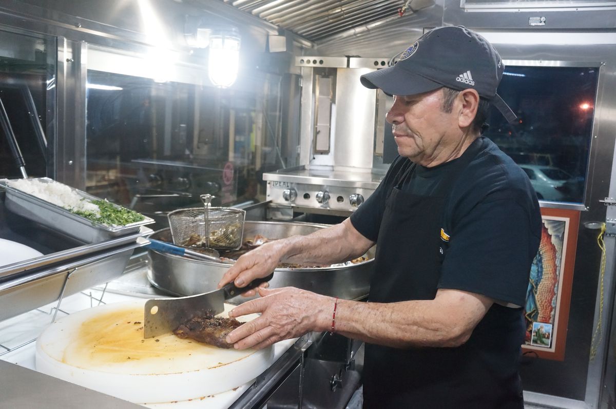 Ramon Torres chopping meat at Tacos Super Monilla