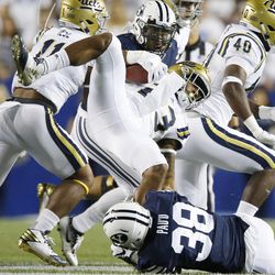 Brigham Young Cougars linebacker Butch Pau'u (38) tackles UCLA Bruins running back Nate Starks (23) for a loss in Provo on Saturday, Sept. 17, 2016.