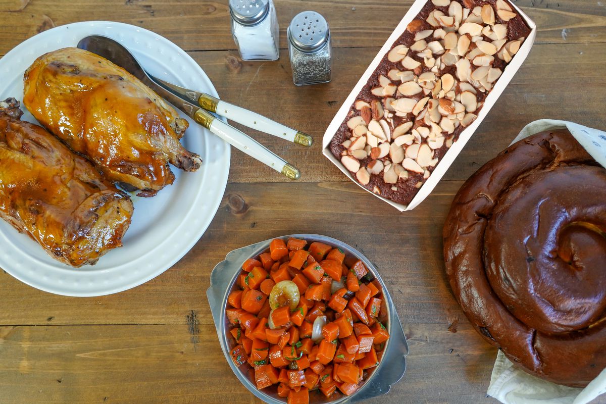 Assorted Rosh Hashanah dishes such as apricot-glazed roast chicken and honey cake from Wise Sons.