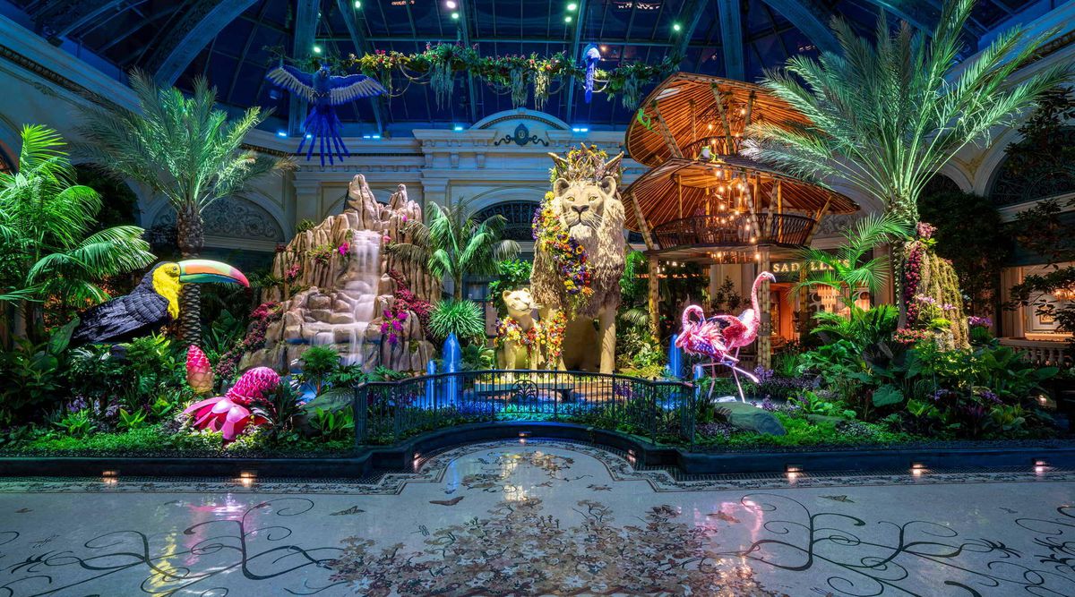 A 20-foot-tall lion made with flowers, standing behind a waterfall, inside the Bellagio Conservatory and Botanical Gardens 