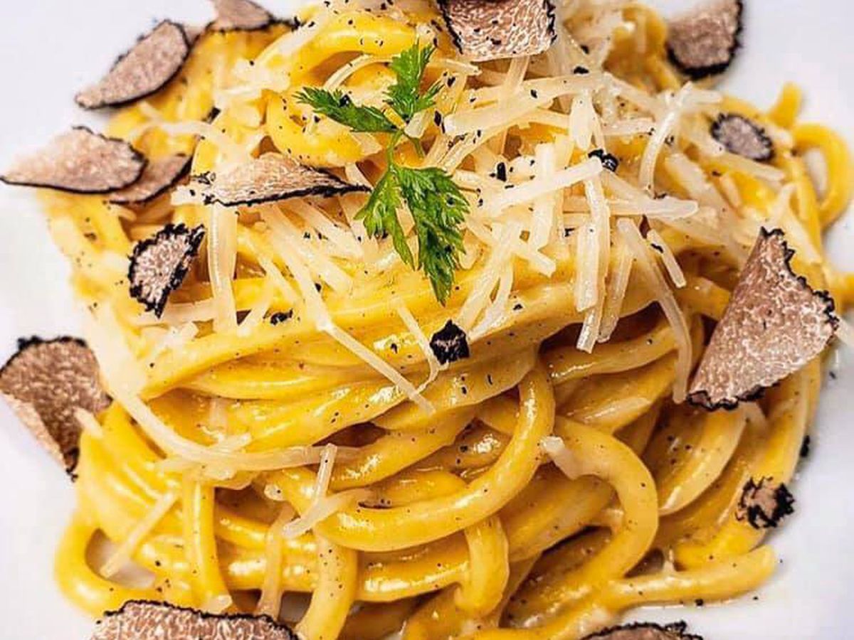 Spaghetti with shaved black truffles and dusted with shredded parmesan.