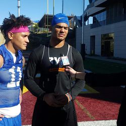 Troy Warner, left, and brother Fred, are both starters on BYU's defense. Here they talk to a San Diego TV station reporter before the Cougars' practice at Southwestern Community College Monday in San Diego.