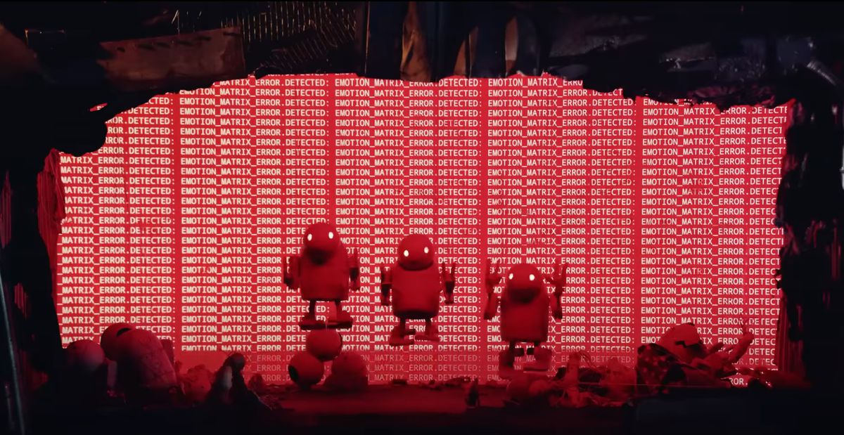 three robot puppets leaping in unison while surrounding by dead robot bodies and a red error message screen in the background.