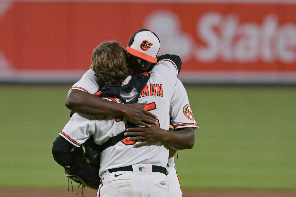 Catcher Adley Rutschman hugs pitcher Felix Bautista after the Orioles close out the 8-5 win