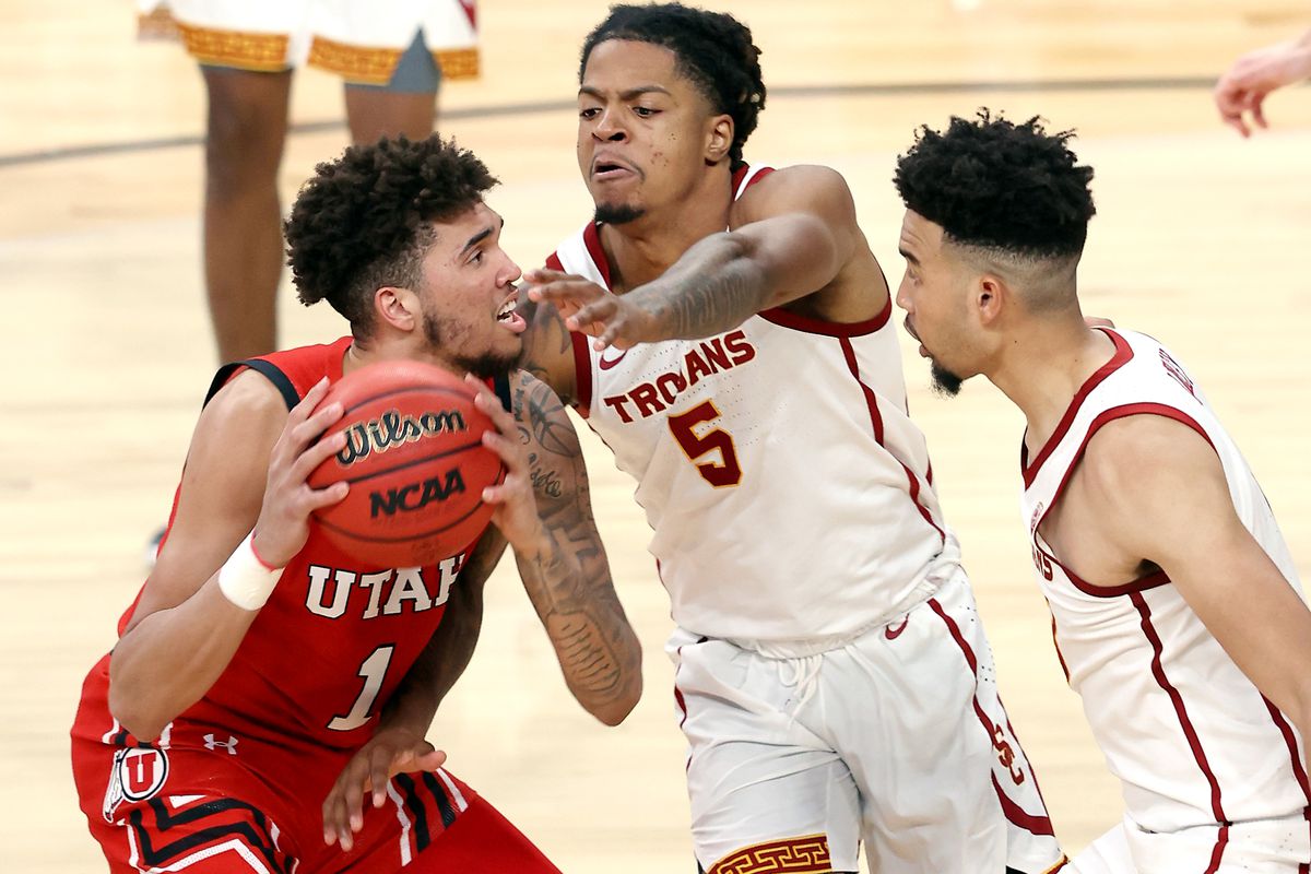Utah Utes forward Timmy Allen (1) works to get off a shot with USC Trojans guard Isaiah White (5) defending him as Utah and USC play in the Pac-12 Tournament at T-Mobile Arena in Las Vegas on Thursday, March 11, 2021. USC won 91-85 in double overtime.