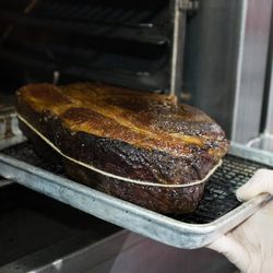 The steak is brought to temperature in a 350° oven. Approximately half way through the cooking process the cap, which is thinner than the eye, is removed, as it cooks quicker than the rest of the steak. 