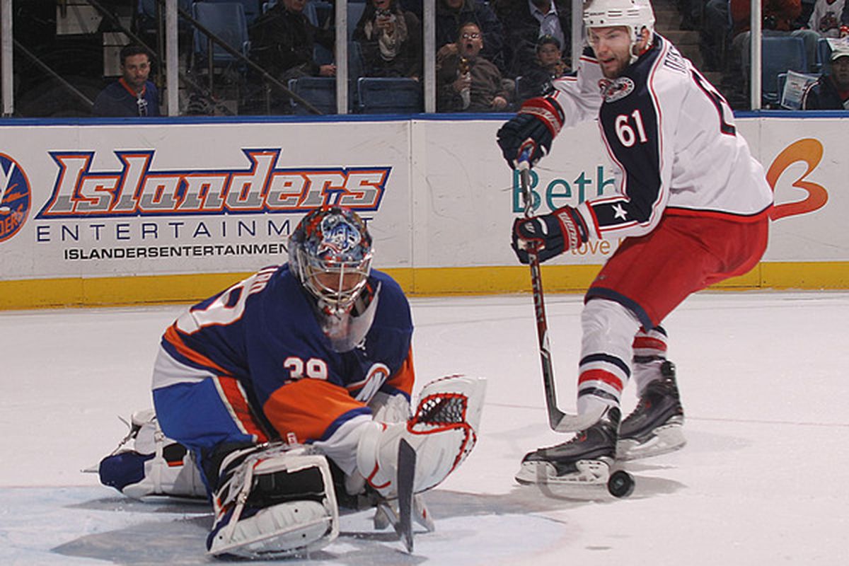 UNIONDALE NY - NOVEMBER 24: Rick Nash #61 of the Columbus Blue Jackets is stopped by Rick DiPietro #39 of the New York Islanders at the Nassau Coliseum on November 24 2010 in Uniondale New York.  (Photo by Bruce Bennett/Getty Images)
