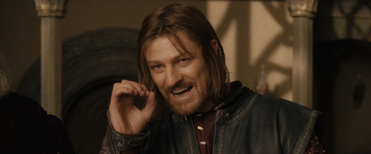 Boromir curls his hand into a circle as he speaks during the Council of Elrond in The Fellowship of the Ring.