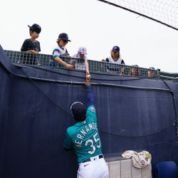  Seattle Mariners outfielder Teoscar Hernandez (35) hands a ball to a fan between inning during a spring training gainst the Chicago White Sox at Peoria Sports Complex