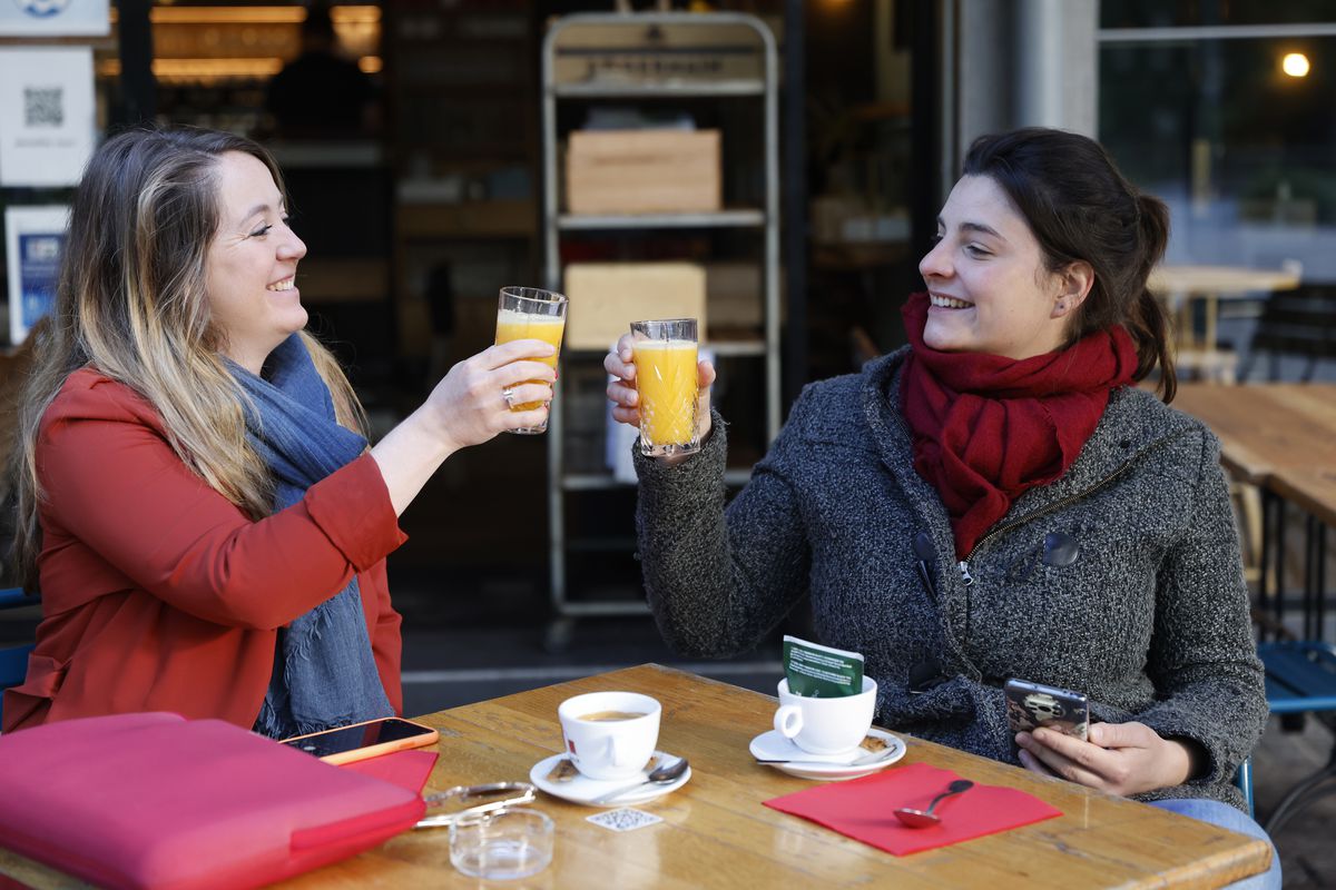 Women enjoy a cafe and an orange juice at a café terrace Wednesday, May, 19, 2021 in Strasbourg, eastern France.