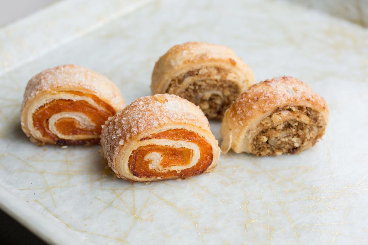 Four rugelach, two filled with apricot and two filled with walnuts.