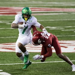 PULLMAN, WA - NOVEMBER 14: Washington State DB Jaylen Watson (0) trips up Oregon RB CJ Verdell (7) on a run in the third quarter of the Pac 12 North divisional matchup between the Oregon Ducks and the Washington State Cougars on November 14, 2020, at Martin Stadium in Pullman, WA.