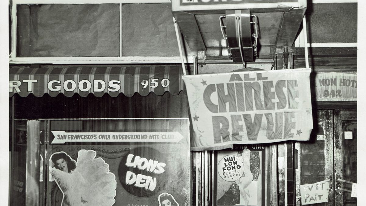 Black and white photo of the exterior of Lion’s Den during the 1940s, with a banner advertising the “All Chinese Revue.”