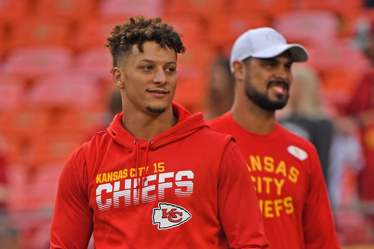 Quarterback Patrick Mahomes of the Kansas City Chiefs looks with quarterback Matt Moore during pre-game workouts, prior to the game against the Indianapolis Colts at Arrowhead Stadium on October 6, 2019 in Kansas City, Missouri.