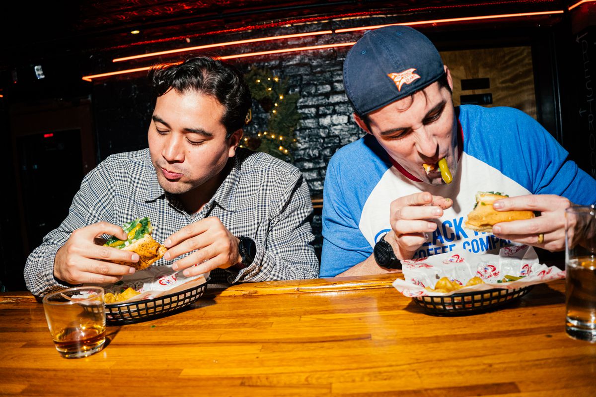 Two customers dig into Chicago dogs at Pubkey in Greenwich Village.