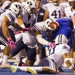 Brigham Young linebacker Fred Warner (4) forces a fumble during the second half of an NCAA football game between Boise State and Brigham Young in Boise on Friday, Oct. 20, 2016. Boise State defeated Brigham Young 28-27 in a wild game.