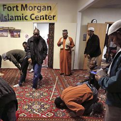 In this Dec. 18, 2015 photo, worshippers observe the weekly Friday Muslim prayer inside a makeshift mosque in Fort Morgan, a small farm town on the eastern plains of Colorado. With a population of roughly 12,000, Supporters of U.S. plans to take in thousands of Syrians fleeing war argue that East African refugees have assimilated in U.S. communities. But assimilation is a lengthy process, one still very much under way for Somali refugees who now count for one of every 10 residents in this Colorado high plains town. 