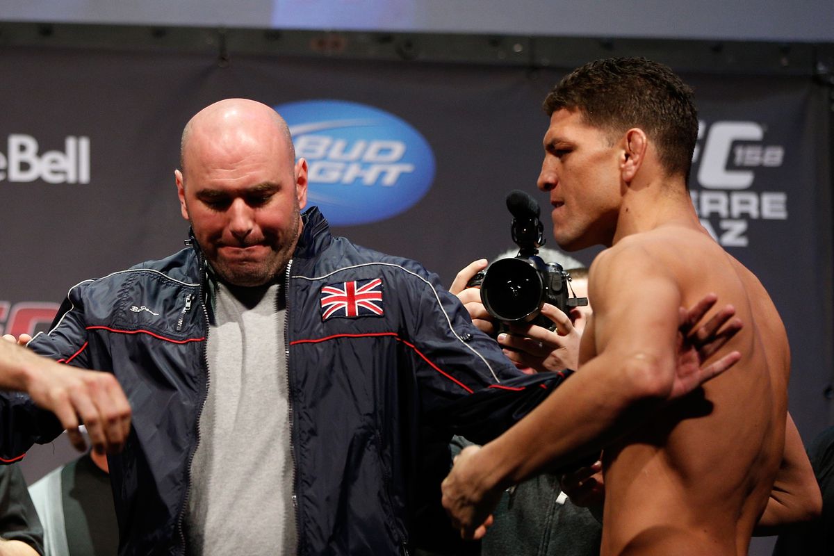 Dana White tries to restrain Nick Diaz during the UFC 158 weigh-ins in 2013. 