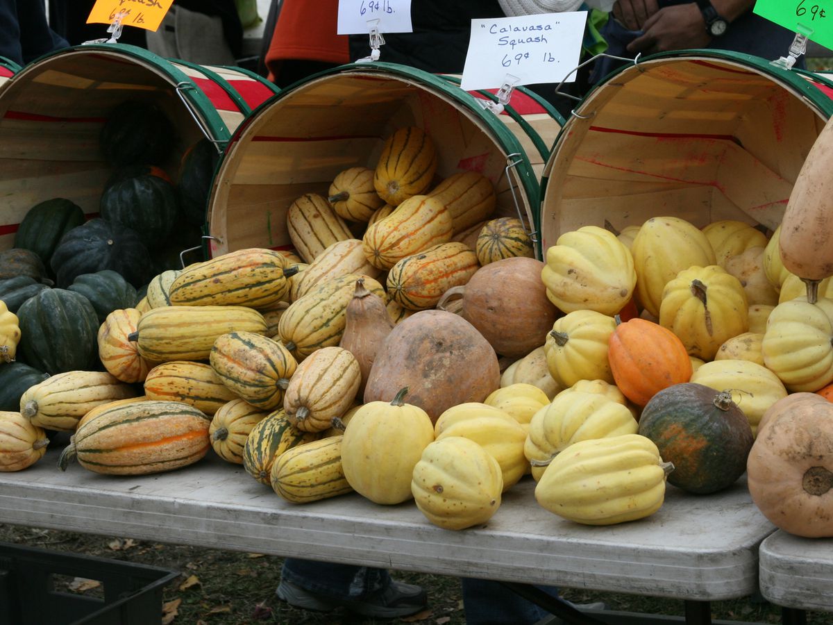 Baskets of gourds and mini pumpkins sit out at a stand for sale at the Green City Market Lincoln Park in Chicago.