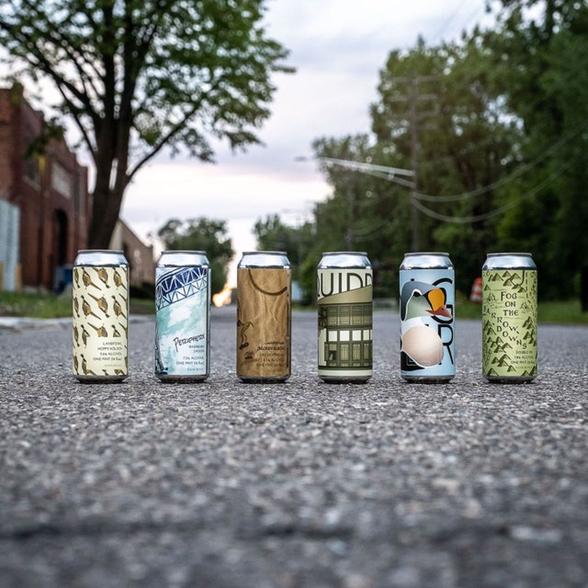 A row of different cans from Brewery Faisan in the middle of the street. 