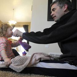 Jeff Griffin plays with his 1-year-old daughter Katelyn in their home in West Jordan on Thursday, Feb. 27, 2014.