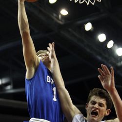 Dixie guard Ryan Wilgar (1) shoots against Desert Hills guard Marcus McKone (12) as Desert Hills and Dixie play in the 3A boys basketball semifinals at the Maverik Center in West Valley City Friday, Feb. 27, 2015.