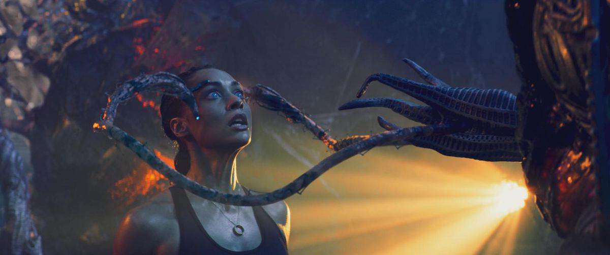 Lindsey Morgan, with glowing eyes, gets a little tentacle probe to the face in Skylines
