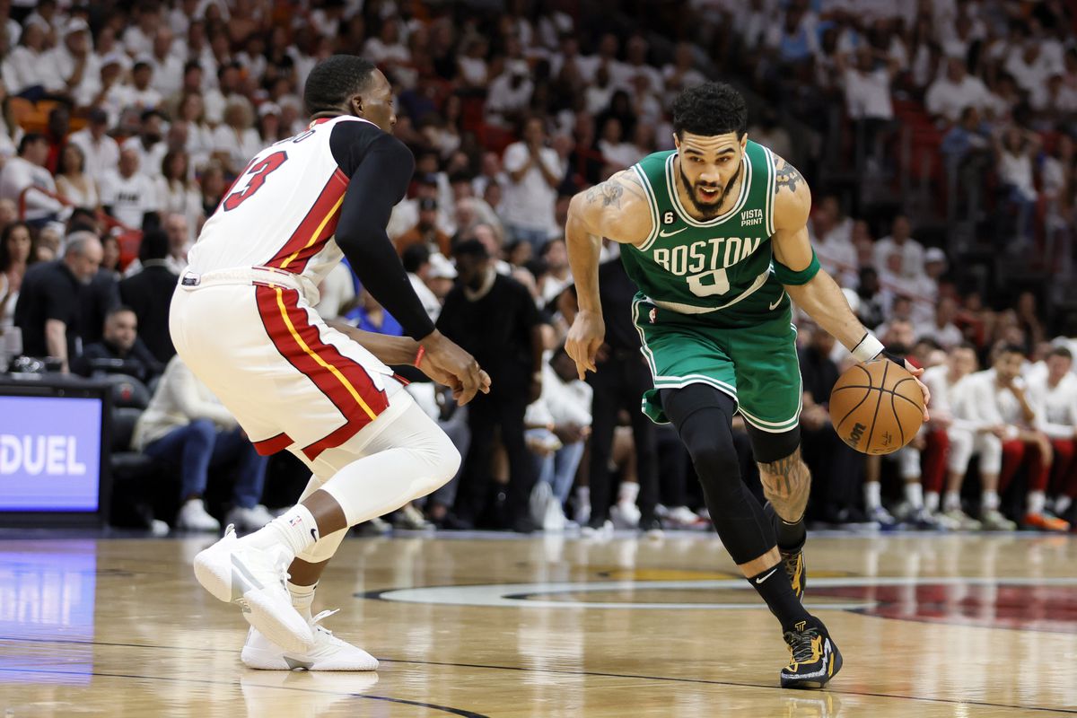 Boston Celtics forward Jayson Tatum (0) controls the ball against Miami Heat center Bam Adebayo (13) in the third quarter during game six of the Eastern Conference Finals for the 2023 NBA playoffs at Kaseya Center.