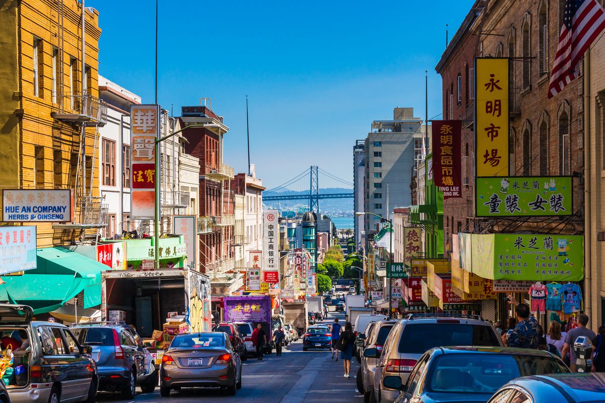 traffic in chinatown with bay bridge in the background