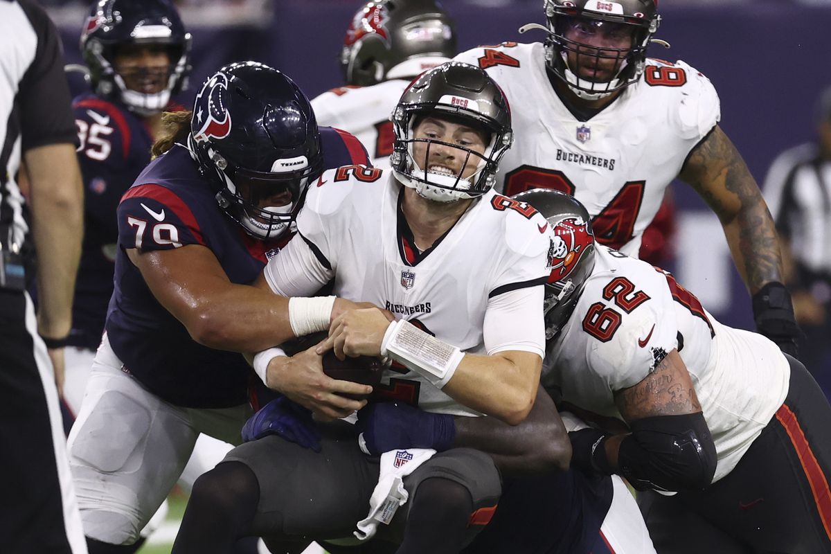 Tampa Bay Buccaneers quarterback Kyle Trask (2) is sacked by Houston Texans defensive tackle Roy Lopez (79) during the fourth quarter at NRG Stadium.&nbsp;