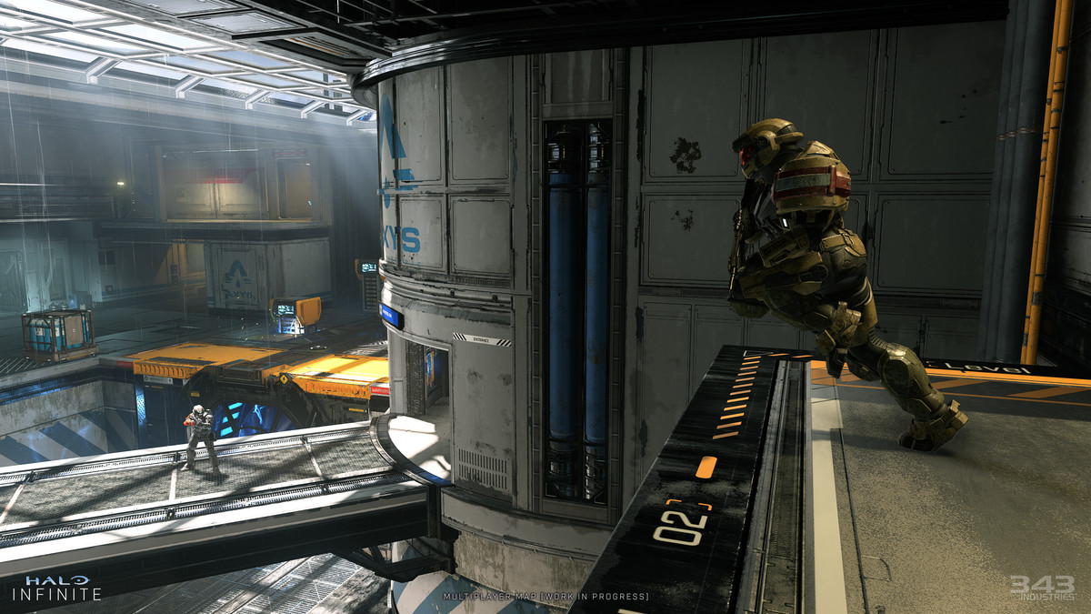 Screenshot of a multiplayer map in Halo Infinite: an armored futuristic soldier runs off a ramp to engage an opponent