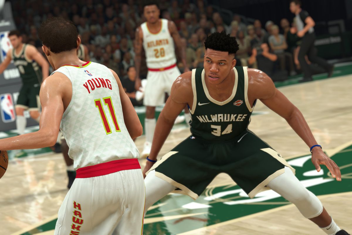 Trae Young sizes up defender Giannis Antetokounmpo at midcourt in NBA 2K21